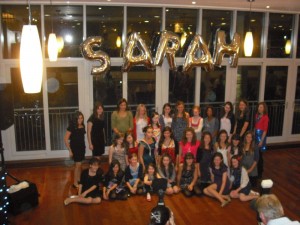 Balloons spelling out Sarah and a group of children at a Bat Mitzvah