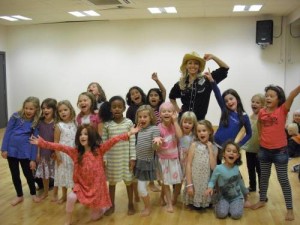 Children posing and teacher wearing a cowgirl costume