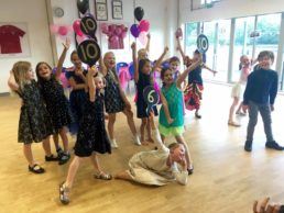 Children holding Strictly score paddles