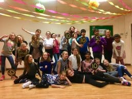 Boys and girls holding Strictly score paddles