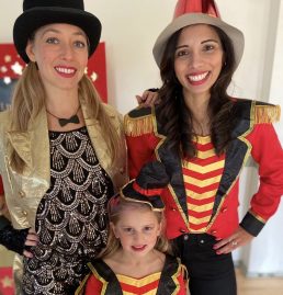 Two party teachers dressed as circus showmen
