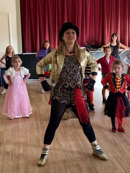Dancer in a top hat and sparkly costume
