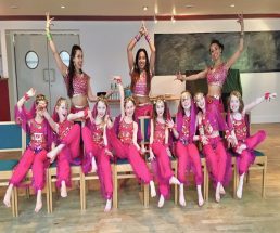 Dances and girls dressed in matching pink Bollywood costumes