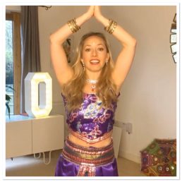 Dancer in a Bollywood costume with hands in preyer position
