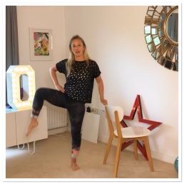 Dancer showing a move holding onto a chair