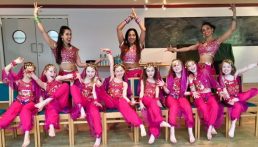 Dances and girls dressed in matching pink Bollywood costumes