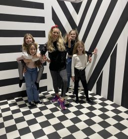 Girls posing in a checked black and white room