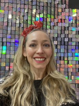 Party teacher smiling with a red headband