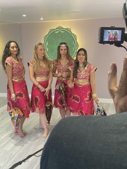 Four female Bollywood dancers in pink costumes