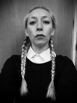 One party teacher in a black and white photo with long plaits