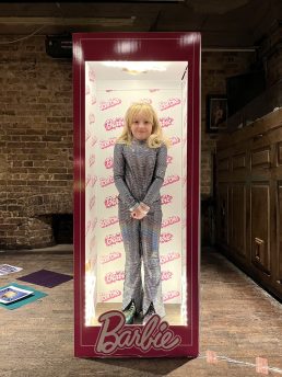 Girl in a light up Barbie box