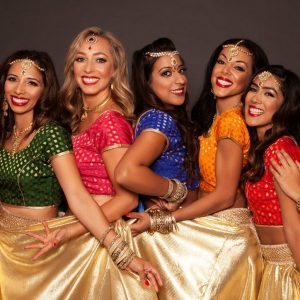 Dancers smiling wearing Indian jewellery