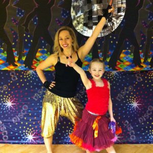 Olivia and birthday girl posing with a big disco ball
